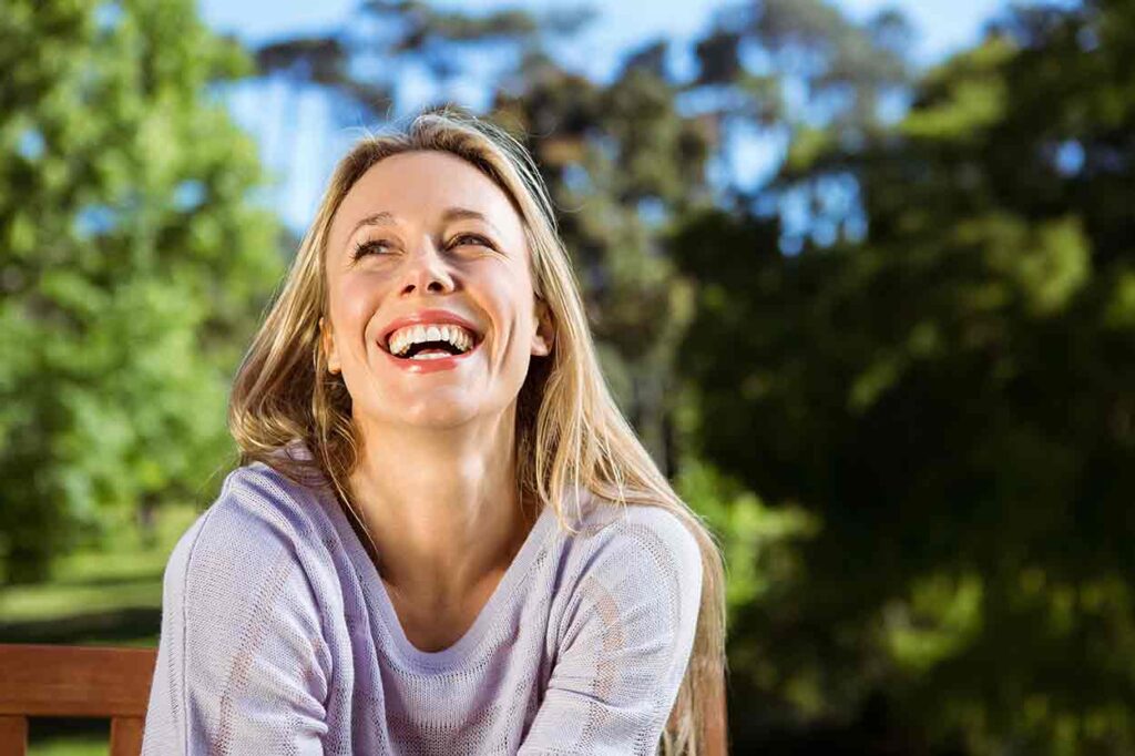 Woman smiling or laughing and looking slightly up to her right.