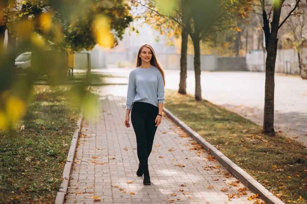 Girl walking in the park, smiling. Using Monkey Bar Meditation