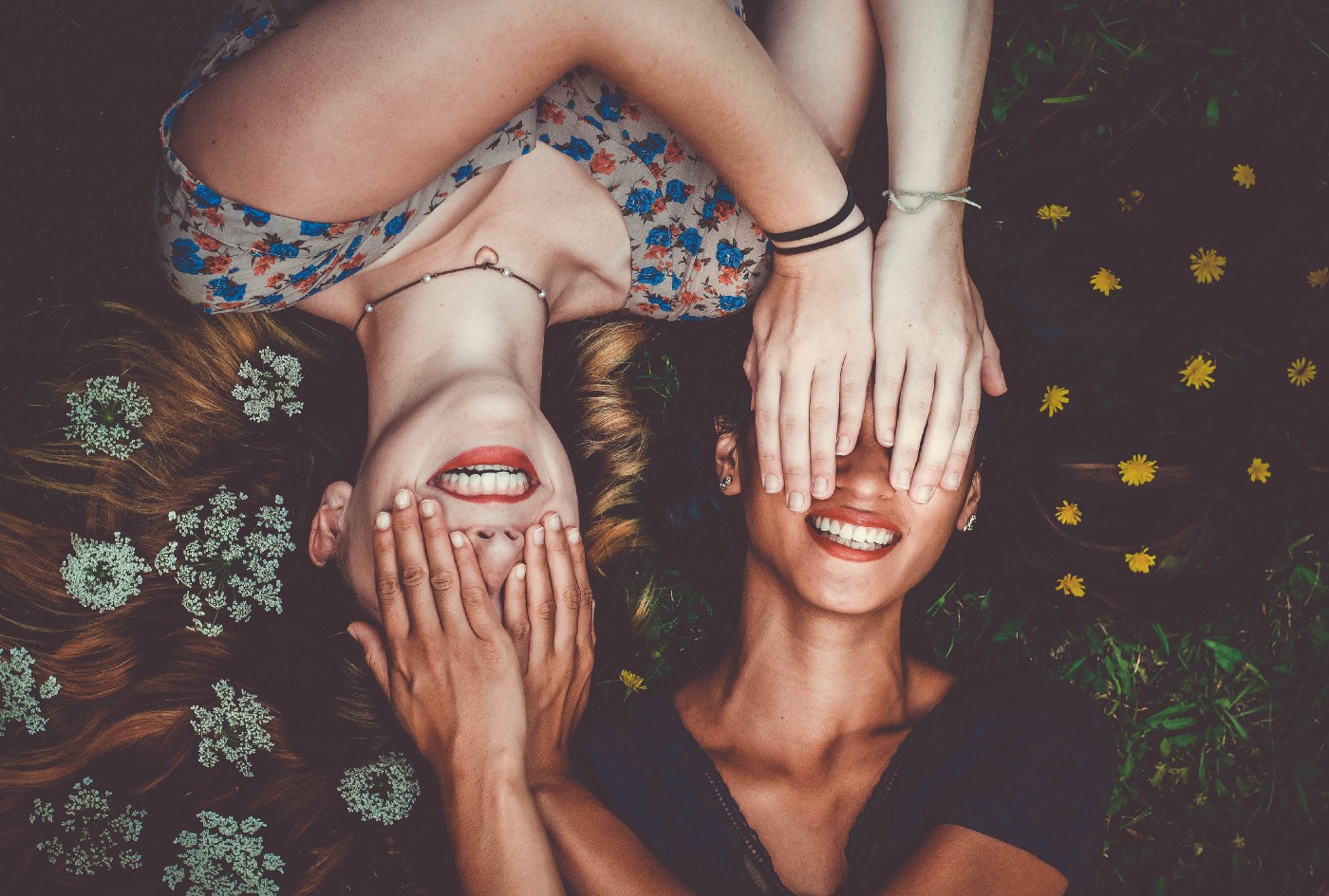 Two girls covering each other's eyes.